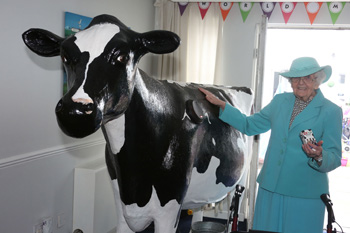 Resident Isobel Waugh whose father was a milkman meets Bella the interactive cow.